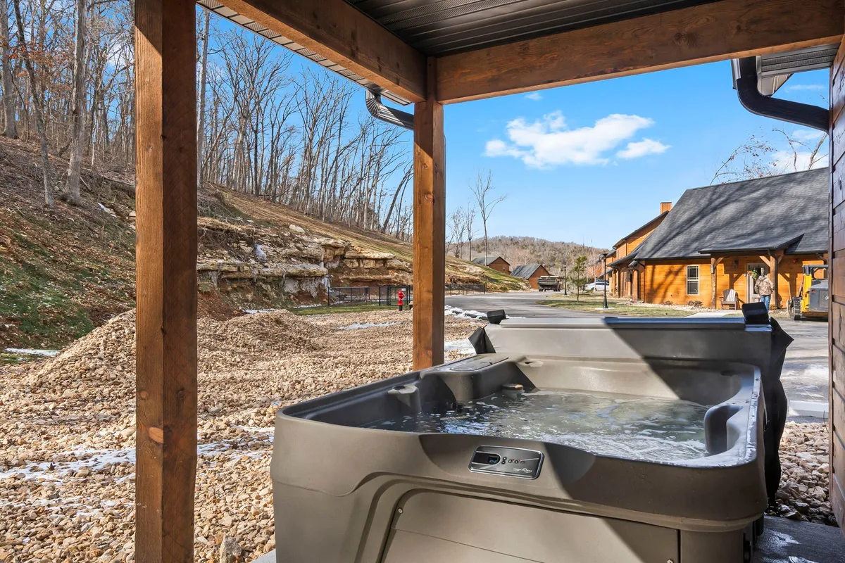 A tranquil exterior view highlights a wooden structure nestled in nature, with a hot tub and surrounding trees. The scene emphasizes peace, privacy, and the opportunity for nature walks right outside the door.